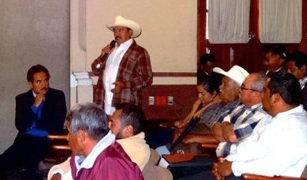 A representative of the indigenous organization Tosepan Titataniske, which produces organic coffee, speaks from the floor of the meeting