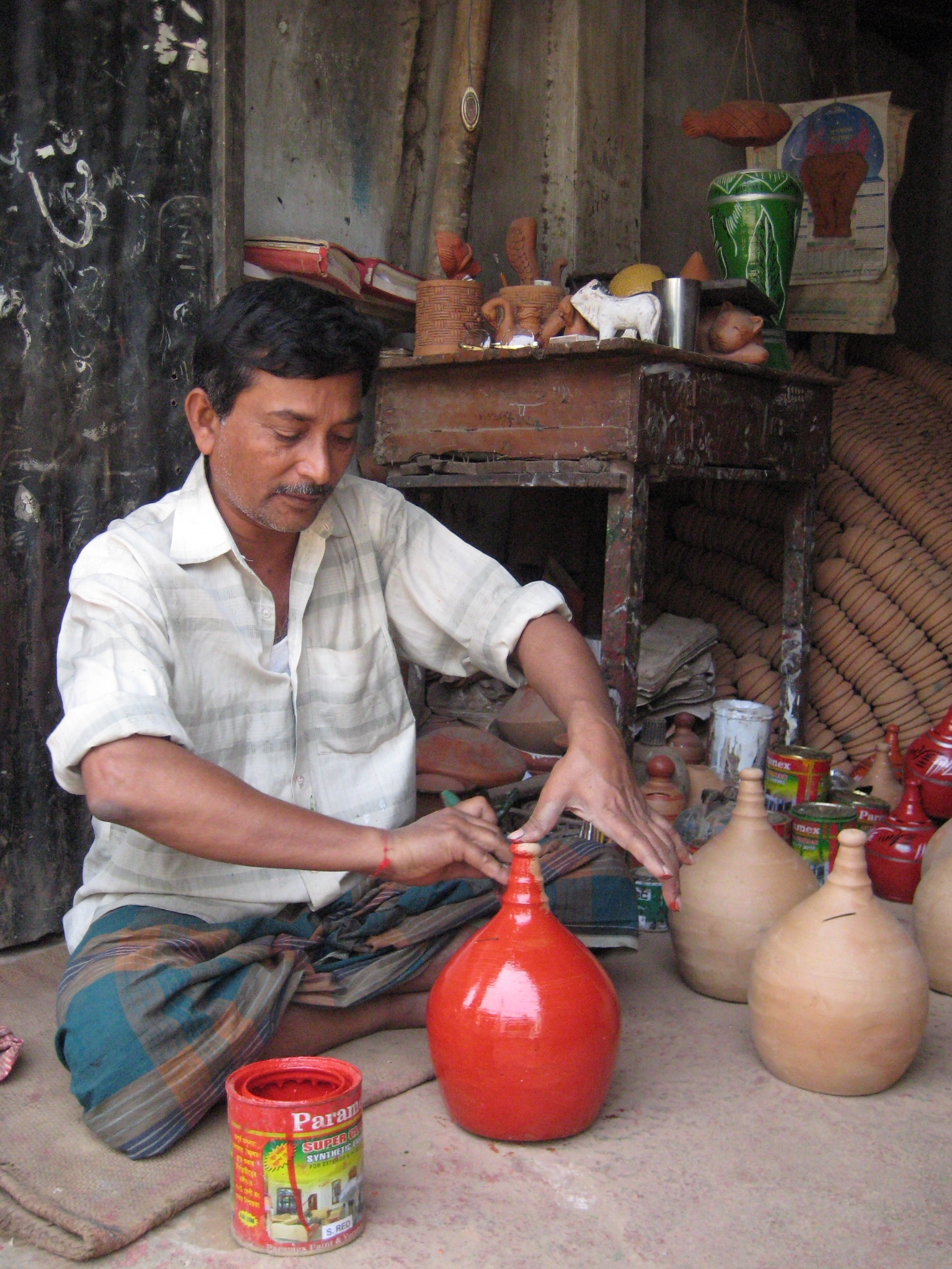 Man painting pottery in Banglades