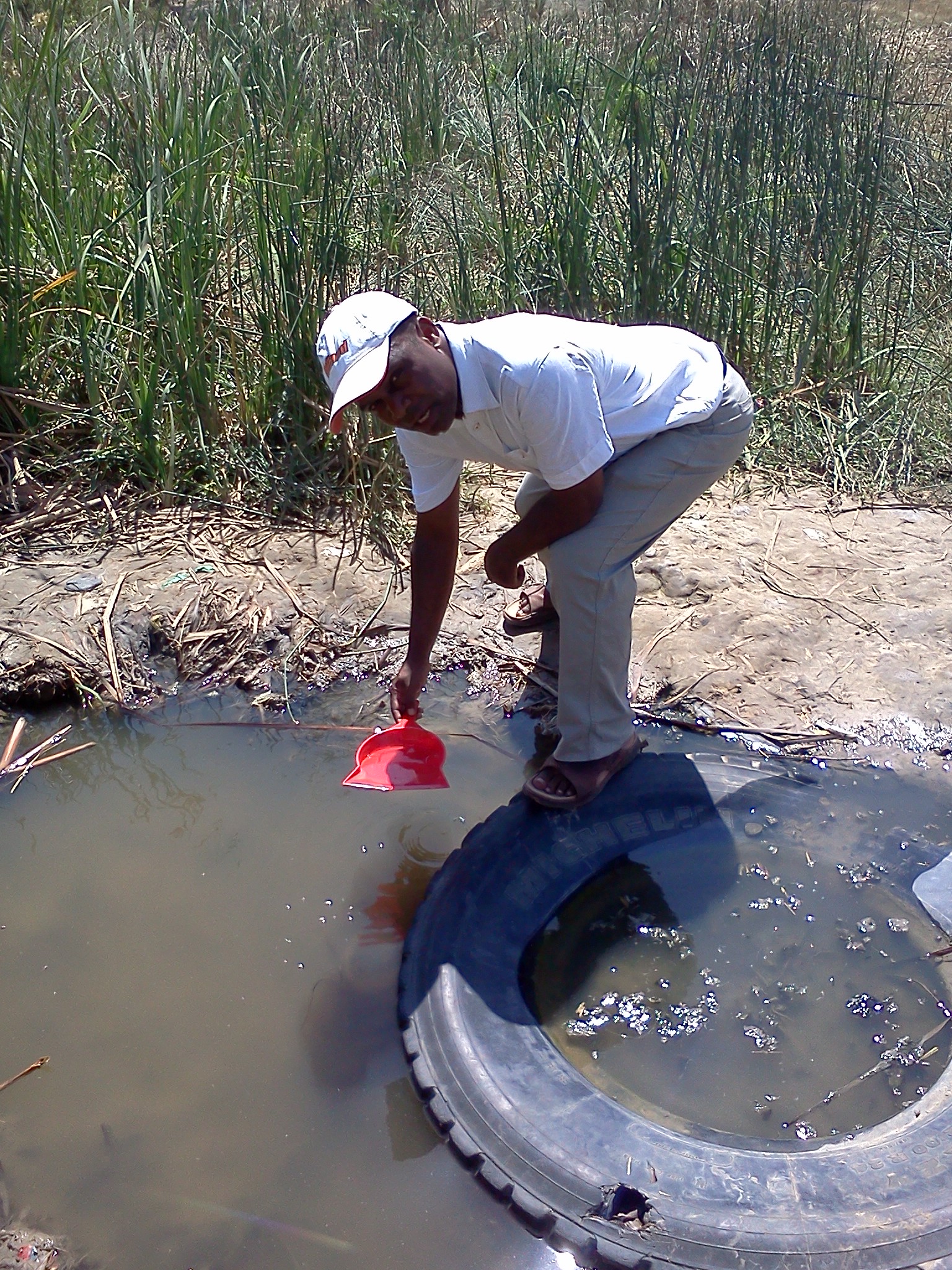 Bernards Okeyo from Eco-Ethics International collecting water samples from the study area