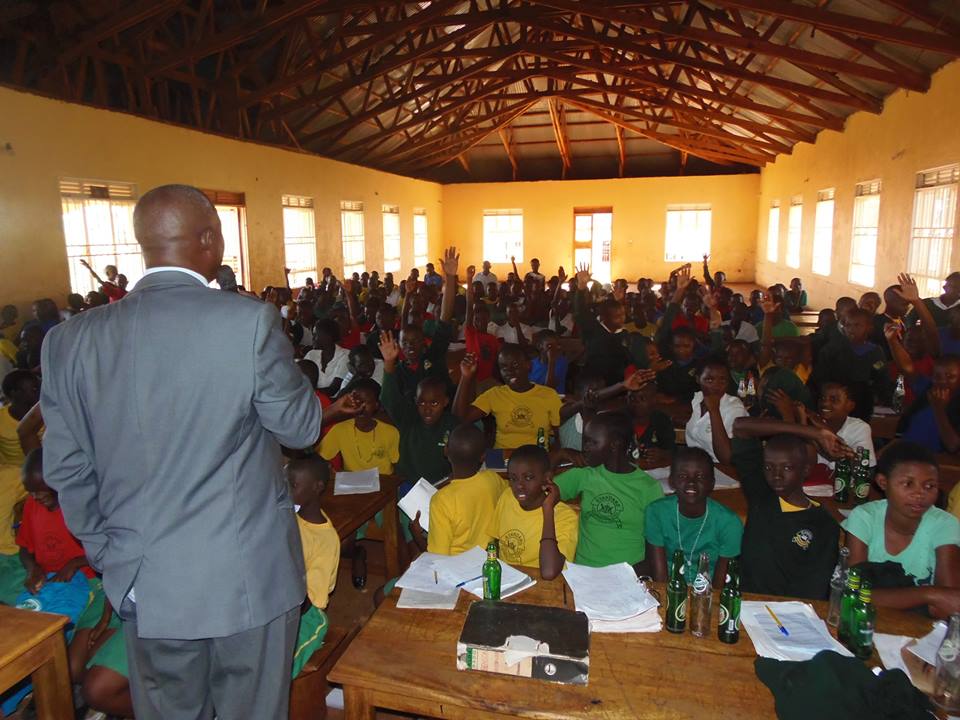 Geoffrey Kamese educating kids at Standard Junior Primary School located in Zaana, Kampala City about lead hazards