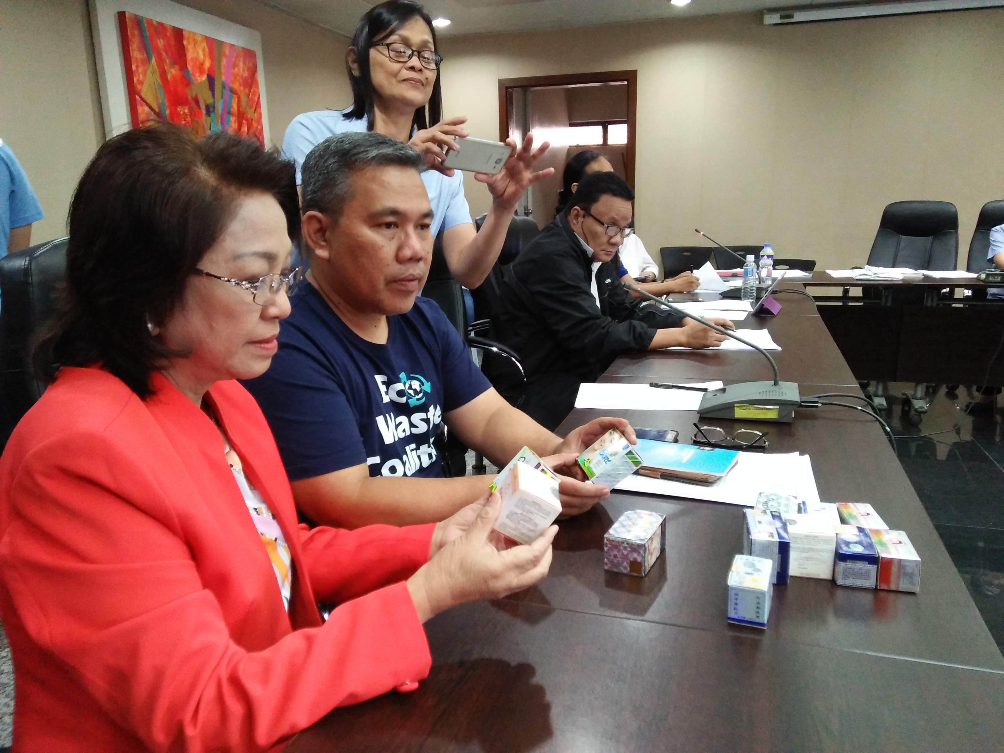Quezon City District 1 Councilor Elizabeth Delarmente inspects contraband cosmetics contaminated with mercury that were obtained by the EcoWaste Coalition during their product test buys in the city.