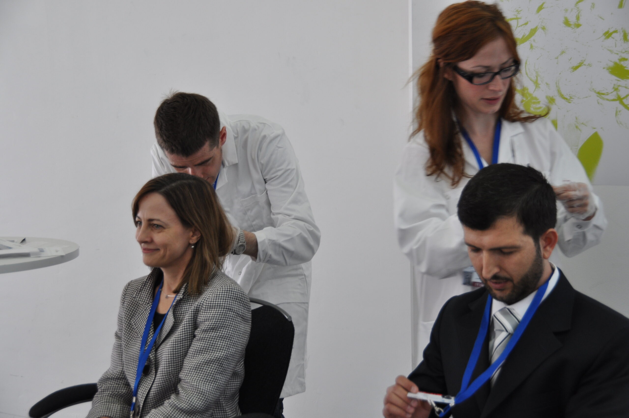 Government delegates offer hair samples to be tested for mercury (Photo by John Wickens)