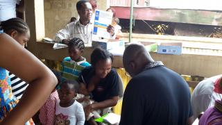 Dr. Chelo, Faculty of Medicine & Biomedical Sciences, University of Yaoundé, interviewing parents