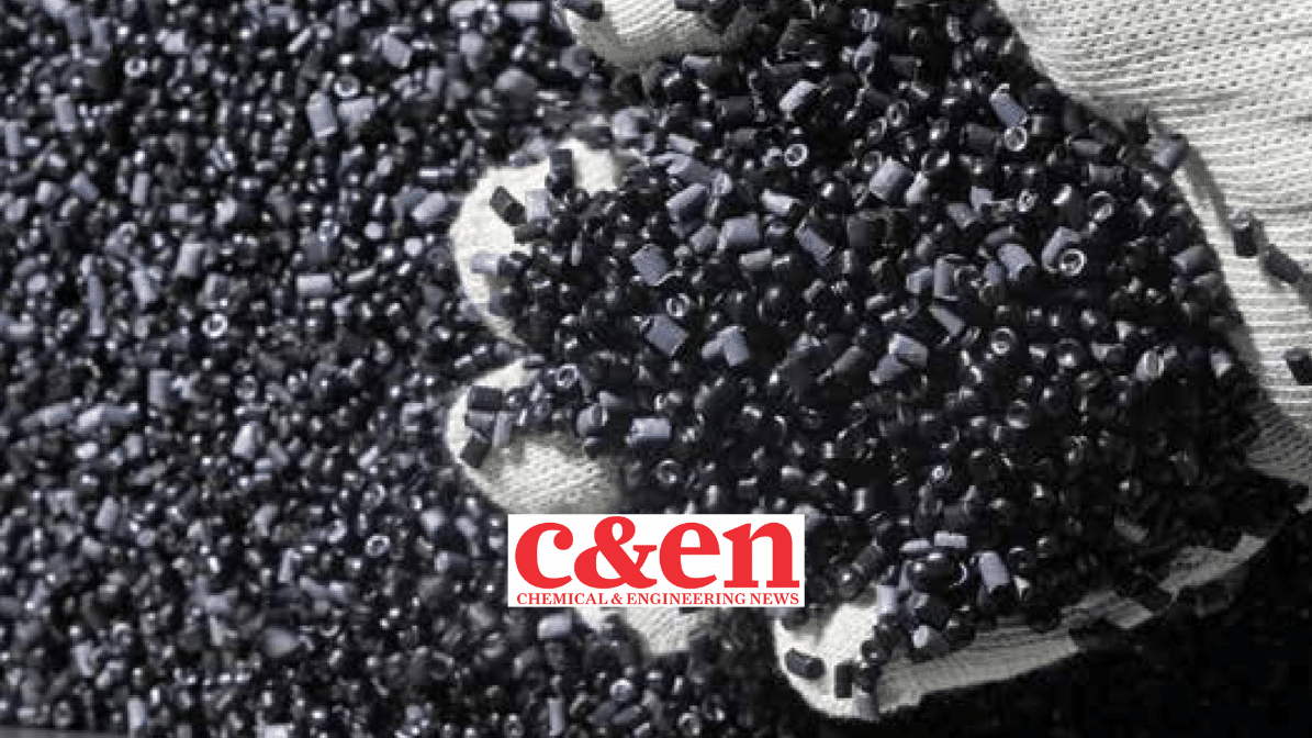 a white glove with a large handful of black plastic pellets, C&EN logo in the foreground