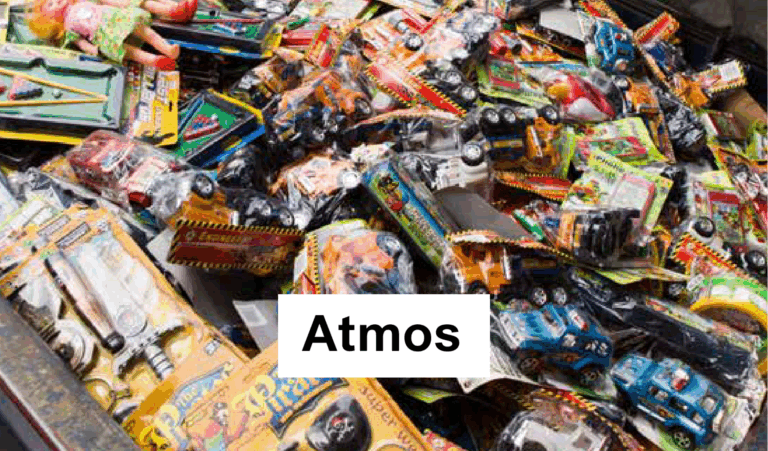 A large pile of packaged plastic toy cars and action figures in various colors fills the frame. The word Atmos is printed in bold on a white rectangle at the center.
