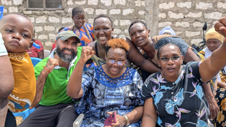 Kenyan people smiling with raised fists in victory