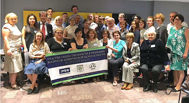 IPEN members from the EECCA region holding a banner in a meeting room.