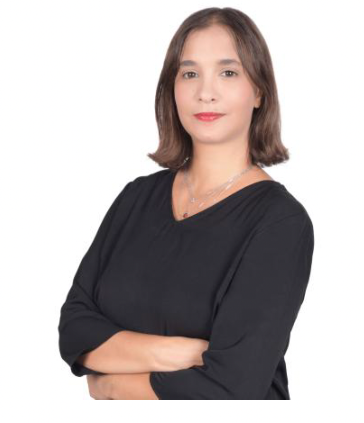 A woman with medium-length brown hair, wearing a black long-sleeve top and a necklace, stands with her arms crossed against a plain white background, ready for the upcoming IPEN meeting.