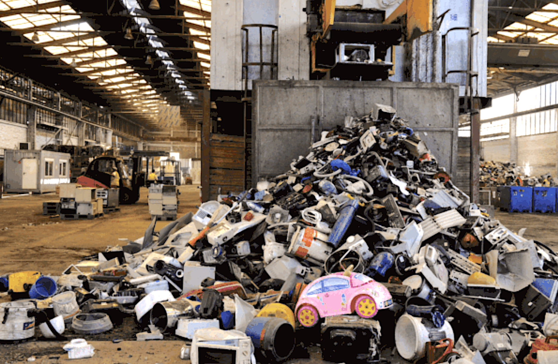 a warehouse with a large pile of plastic waste
